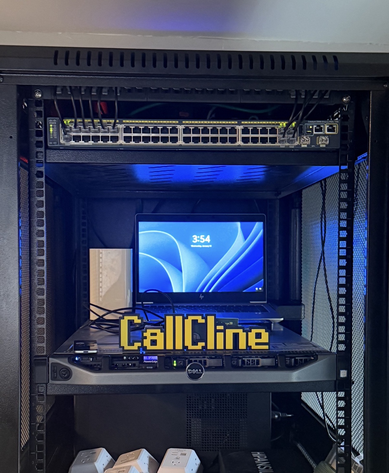 The CallCline server rack, with blue lighting and a CallCline sign