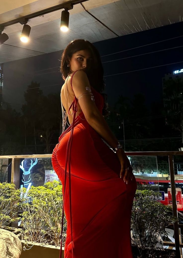 Elegant Ghaziabad escort in a red animal-print dress, offering transparent pricing for luxury hotel visits and dinner dates